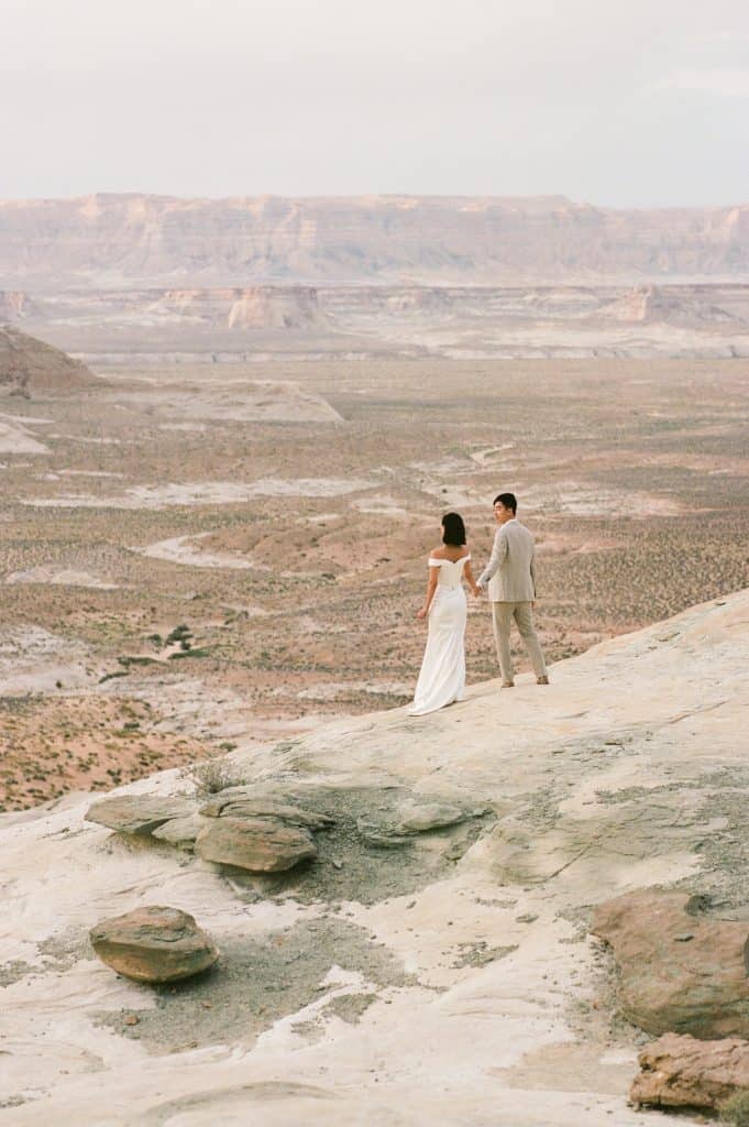 couple stands on edge of canyon in page arizona