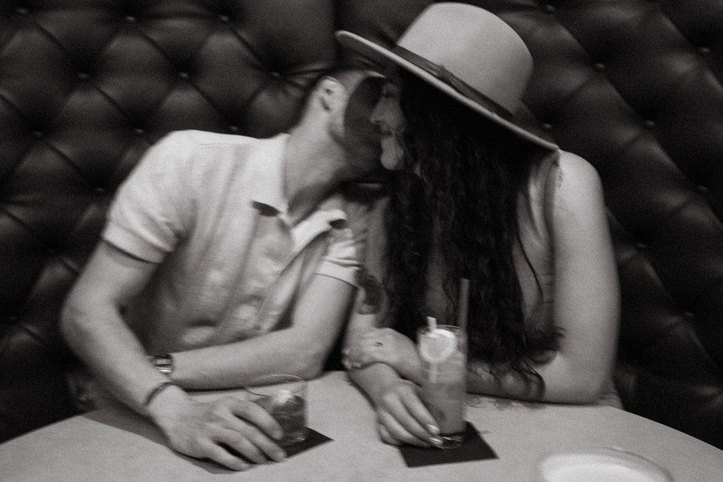 couple snuggles at a bar in salt lake city
